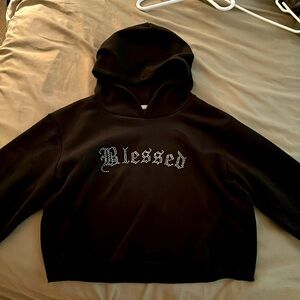 I am selling a black long sleeve hoodied crop top